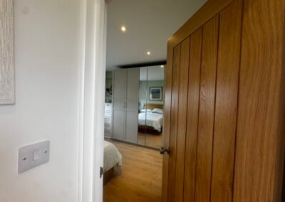 Master bedroom in a Windsor loft conversion with large rear windows