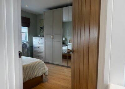 Master bedroom in a Windsor loft conversion with large rear windows