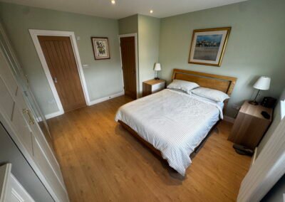 Master bedroom in a Windsor loft conversion with large rear windows