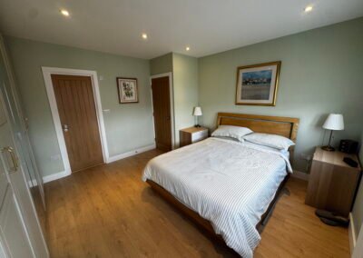 Master bedroom in a Windsor loft conversion with large rear windows