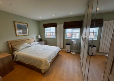 Master bedroom in a Windsor loft conversion with large rear windows