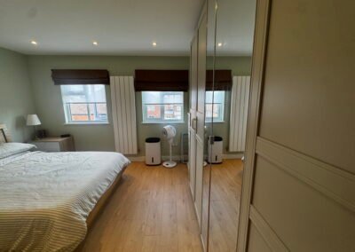 Master bedroom in a Windsor loft conversion with large rear windows