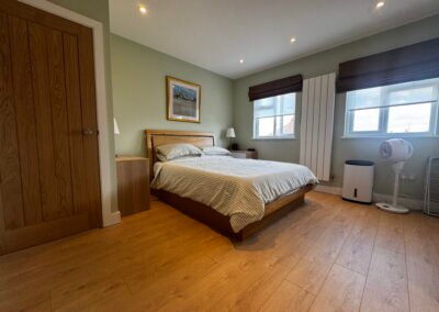 Master bedroom in a Windsor loft conversion with large rear windows