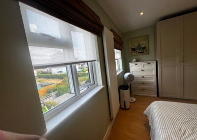 Master bedroom in a Windsor loft conversion with large rear windows