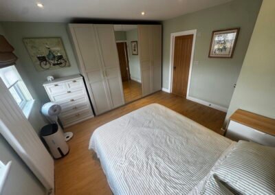 Master bedroom in a Windsor loft conversion with large rear windows