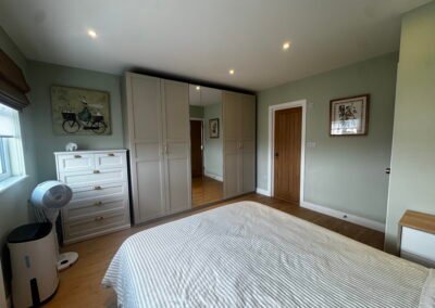 Master bedroom in a Windsor loft conversion with large rear windows