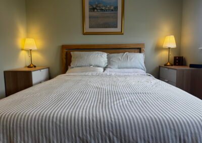 Master bedroom in a Windsor loft conversion with large rear windows