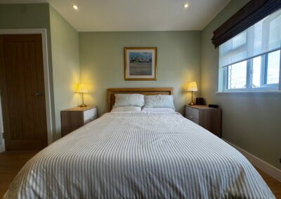Master bedroom in a Windsor loft conversion with large rear windows